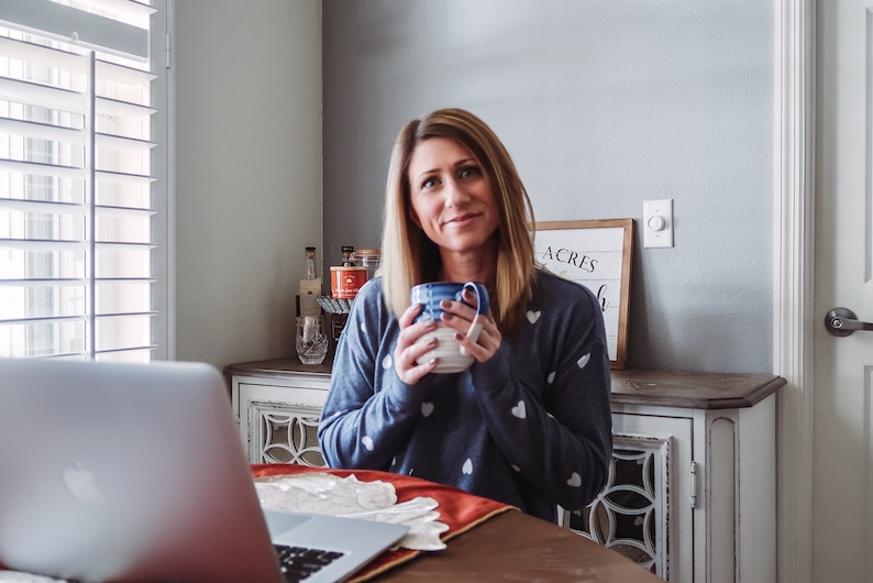 Girl sitting with coffee mug and computer